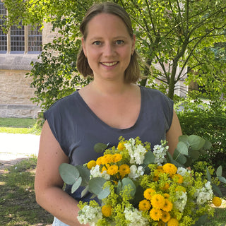 2 Frauen , pink gekleidet, im Gruppenbild mit ihren Werkstücken aus dem Trockenblumen Workshop in Muenster. Beide lächeln in die Kamera und haben ihre gebastelten Blumensträuße in der Hand.